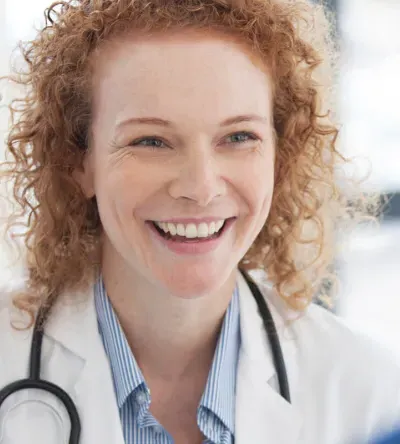 Public health nurse smiling in hospital with RN